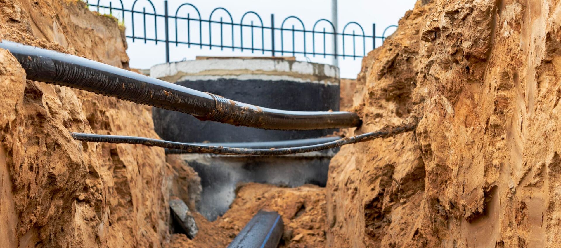 The fiber optic cable is installed in a trench beneath the existing sewerage engineering networks